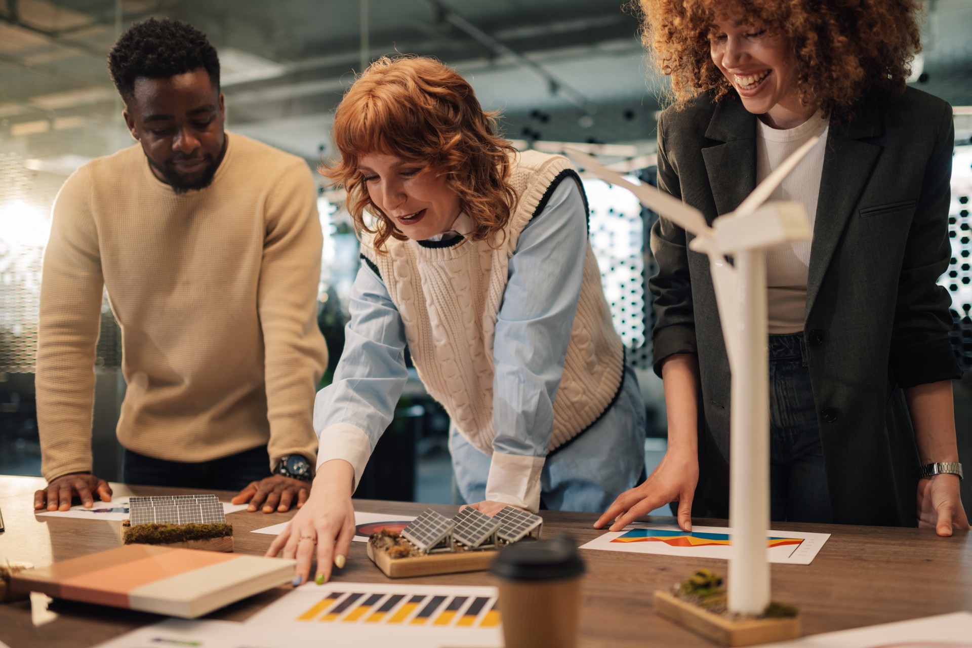 Eco conscious diverse staff working on global warming solution at office